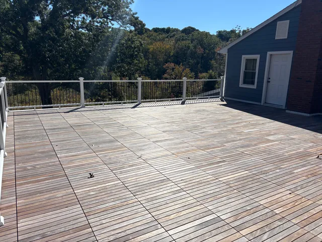 a view of outdoor space with a barbeque grill and wooden floor