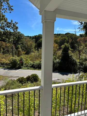 a view of a balcony with wooden fence