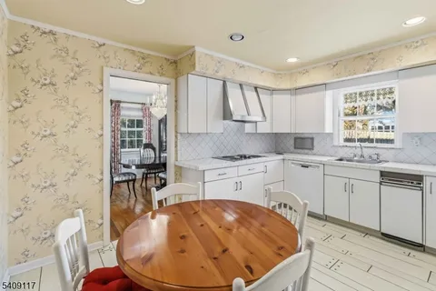 a kitchen with a stove a sink and a refrigerator