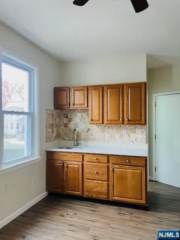 a kitchen with stainless steel appliances granite countertop a sink and a wooden cabinets