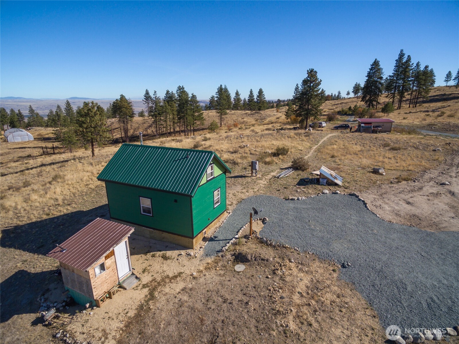 454 Harmony Heights Road Brewster, WA 98812 - Photo 4 of 24 a view of a dry yard with trees