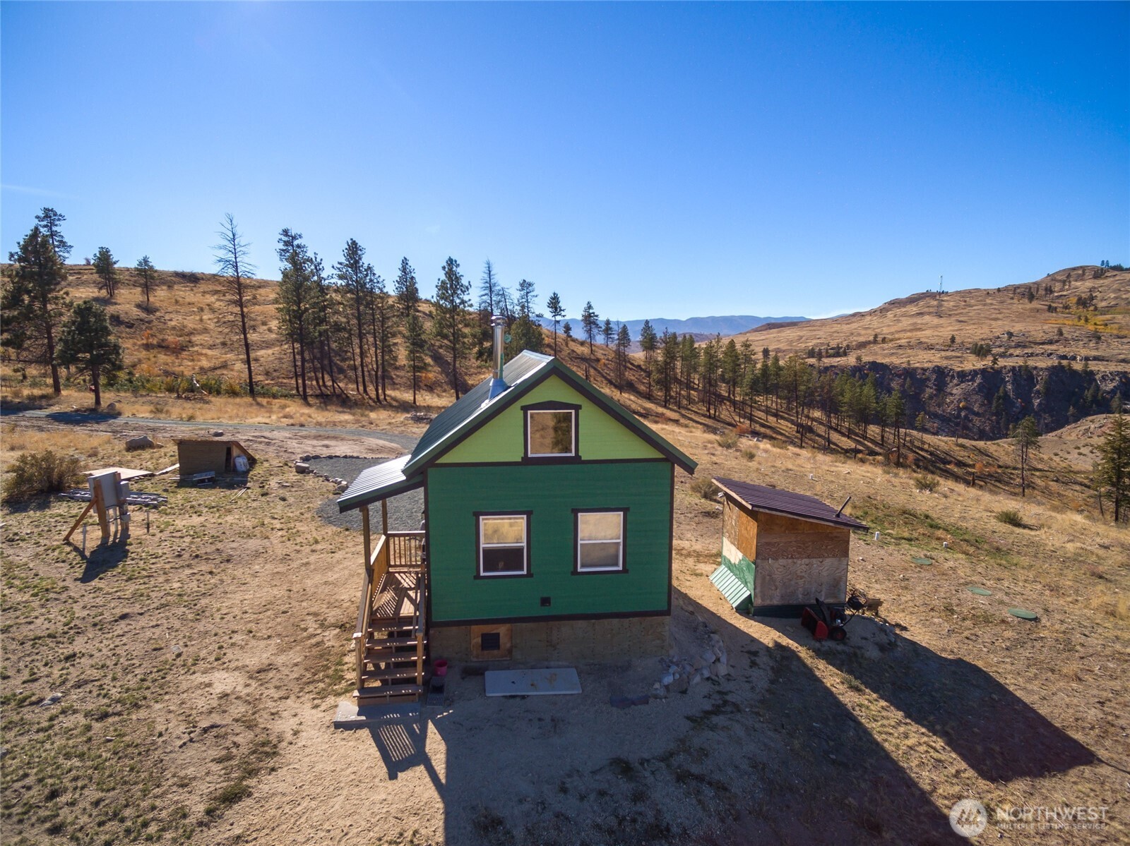 454 Harmony Heights Road Brewster, WA 98812 - Photo 6 of 24 a view of a grey house with a yard