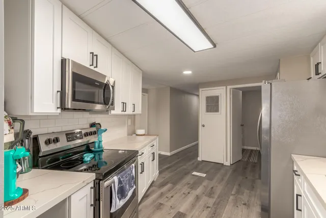 a kitchen with stainless steel appliances granite countertop a stove and a sink