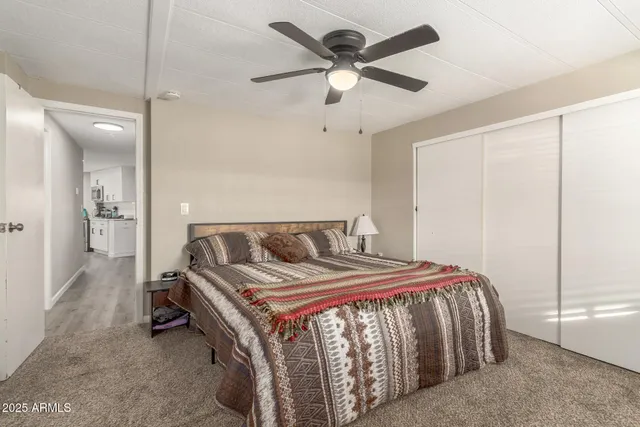 a bed sitting in a bedroom next to a bathroom