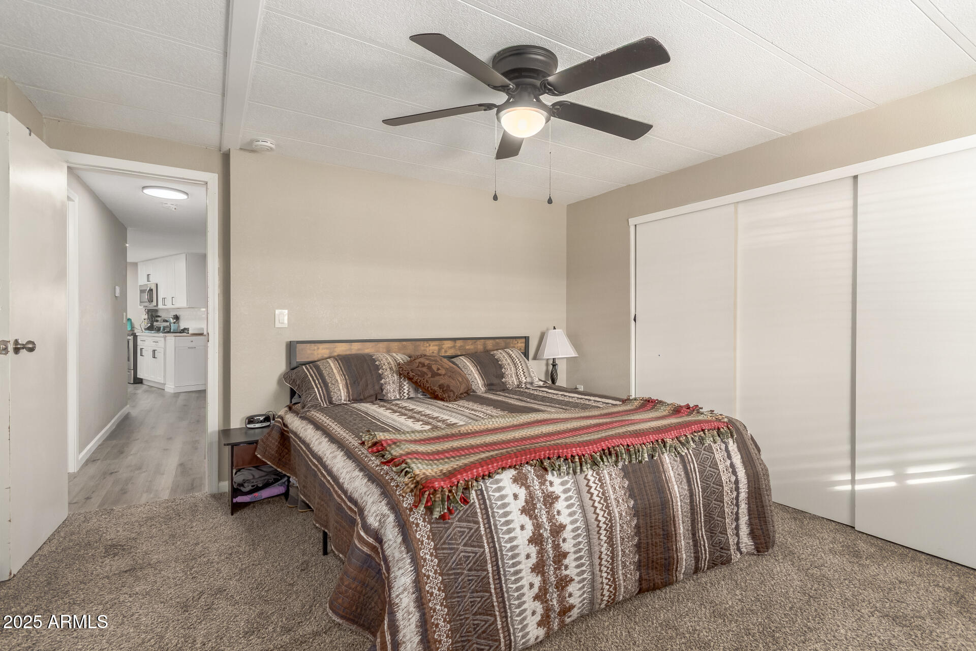 5263 East McDowell Road Mesa, AZ 85215 - Photo 12 of 40 a bed sitting in a bedroom next to a bathroom