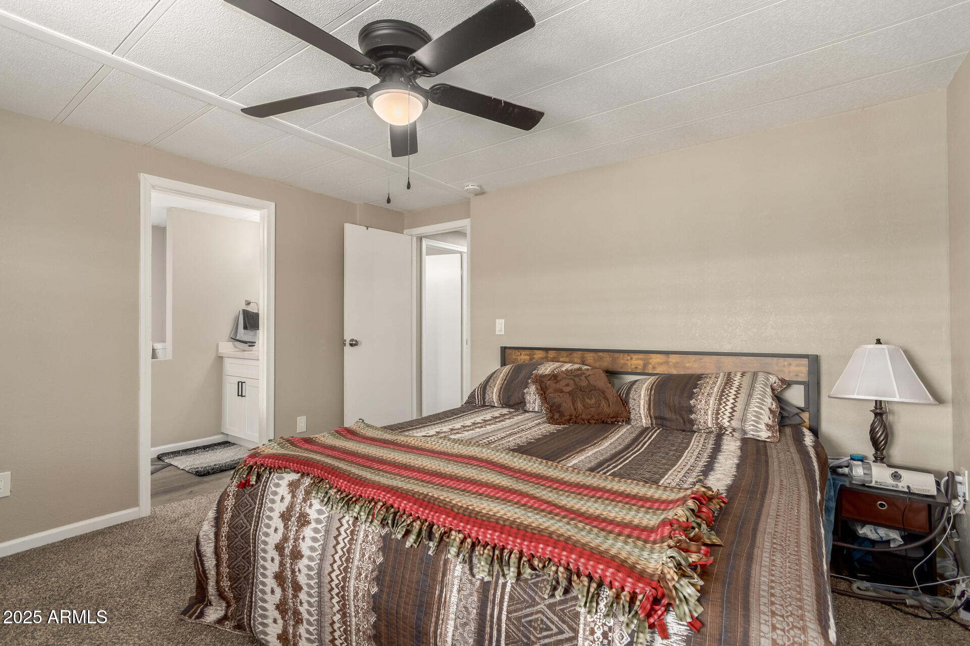 5263 East McDowell Road Mesa, AZ 85215 - Photo 13 of 40 a bedroom with a bed and a chandelier