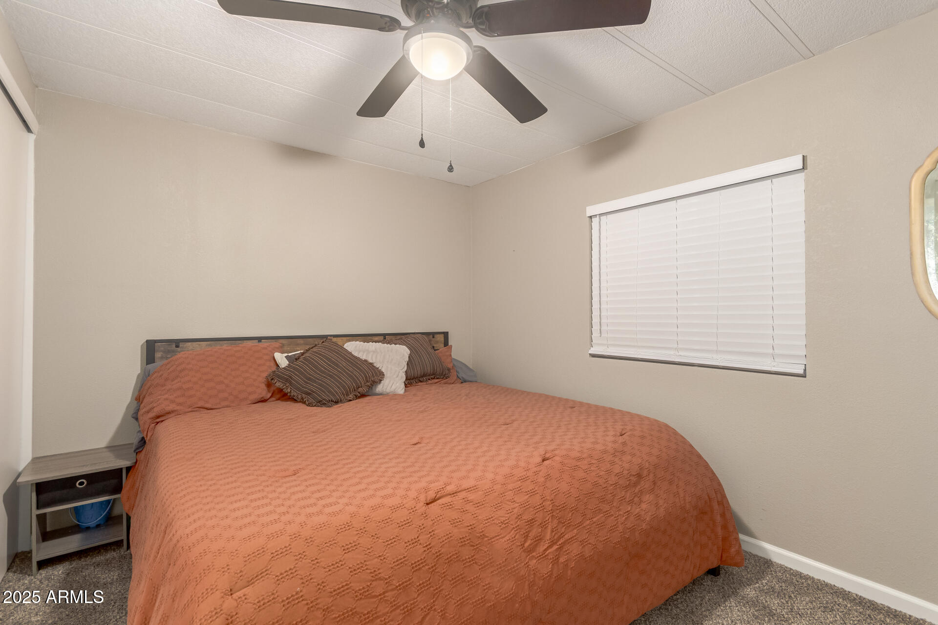 5263 East McDowell Road Mesa, AZ 85215 - Photo 16 of 40 a large bed sitting in a bedroom next to a window