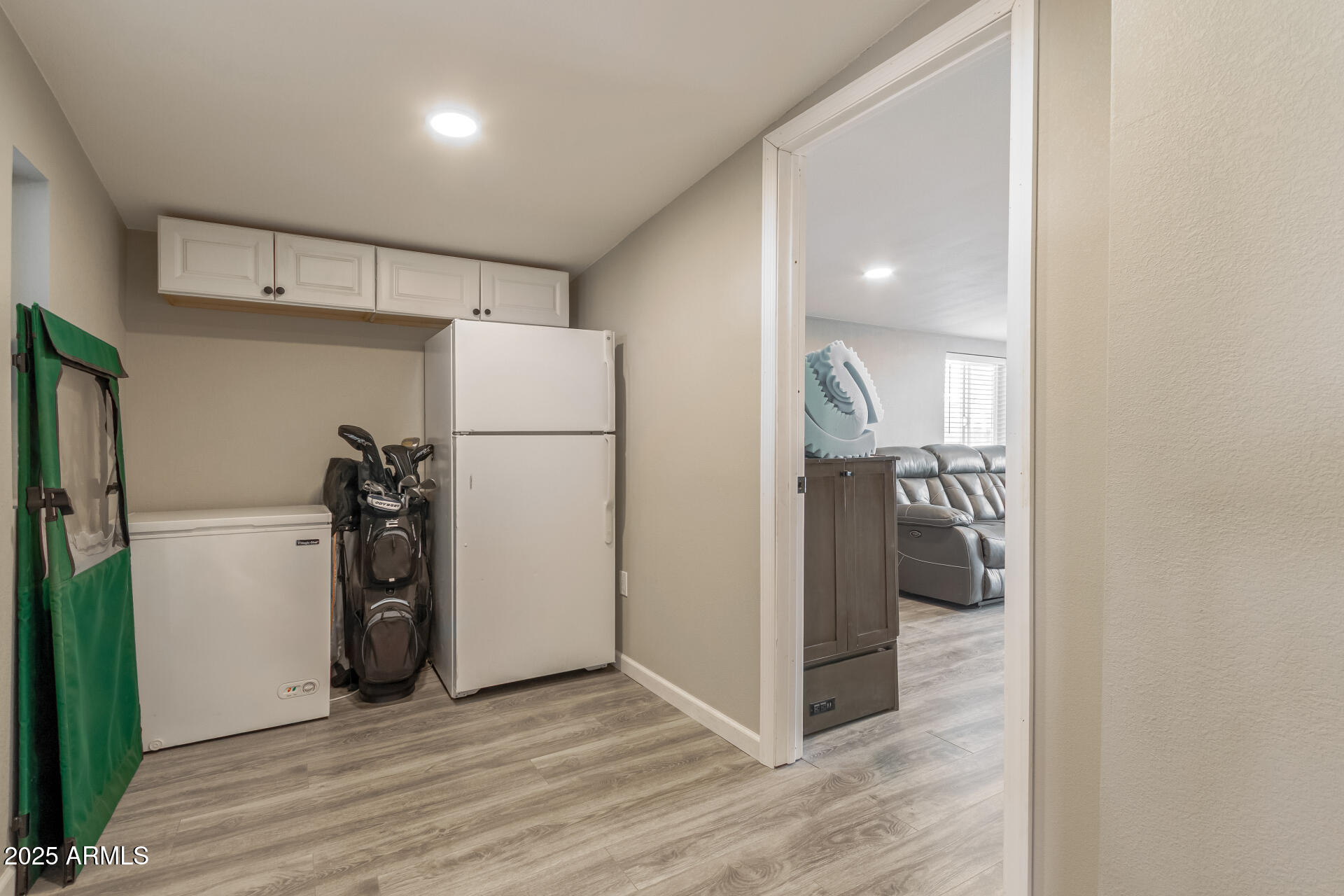 5263 East McDowell Road Mesa, AZ 85215 - Photo 18 of 40 a view of a refrigerator in kitchen and an empty room