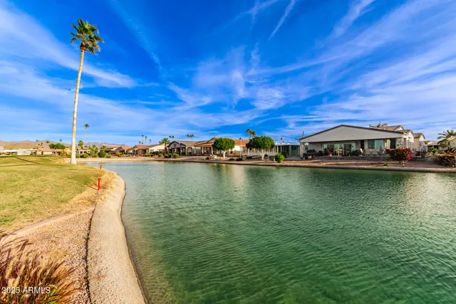 a view of an ocean with a table and chairs