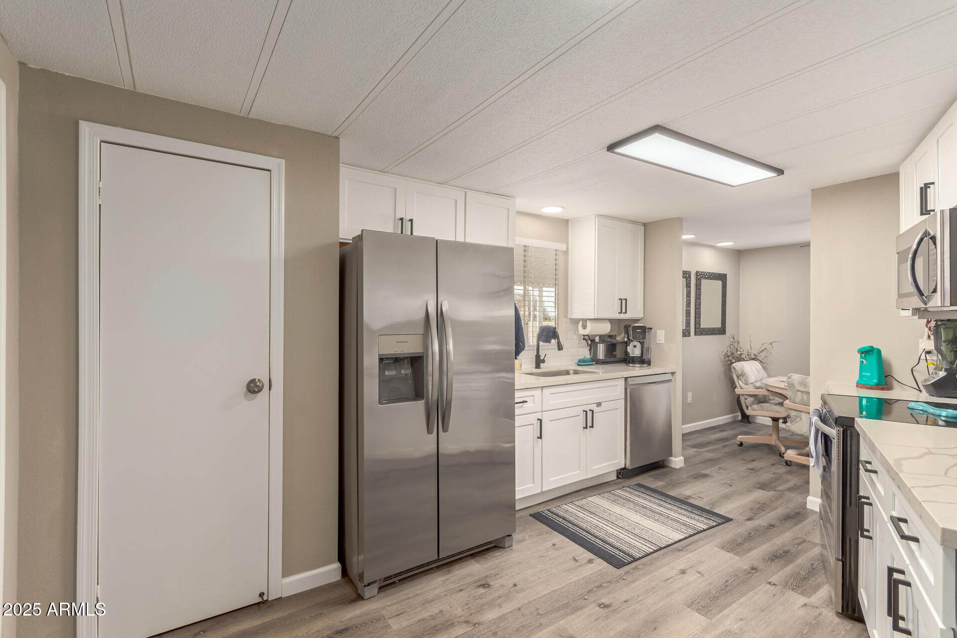 5263 East McDowell Road Mesa, AZ 85215 - Photo 9 of 40 a kitchen with stainless steel appliances a refrigerator sink and cabinets