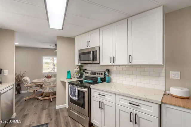 a kitchen with a sink stove and cabinets