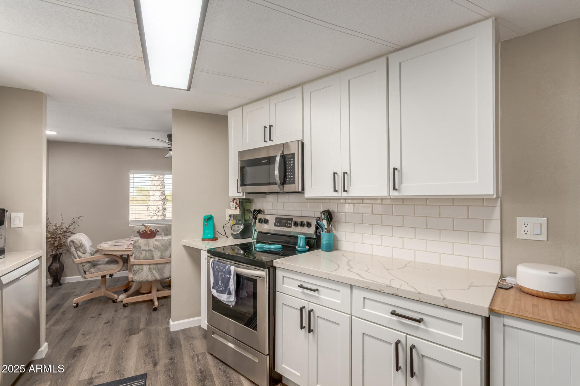 5263 East McDowell Road Mesa, AZ 85215 - Photo 10 of 40 a kitchen with a sink stove and cabinets