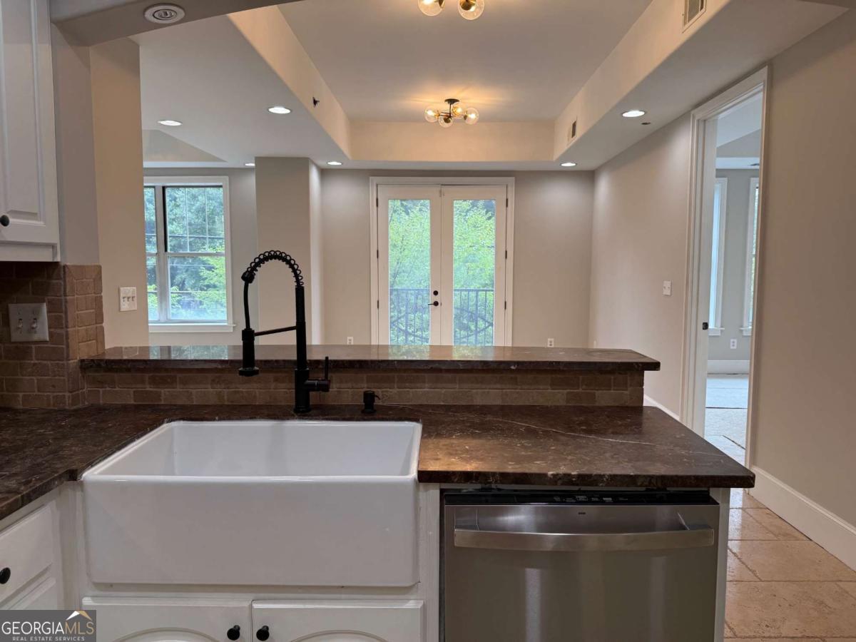 2255 Peachtree Road Northeast, Unit 322 Atlanta, GA 30305 - Photo 12 of 31 a view of a sink and dishwasher with wooden floor