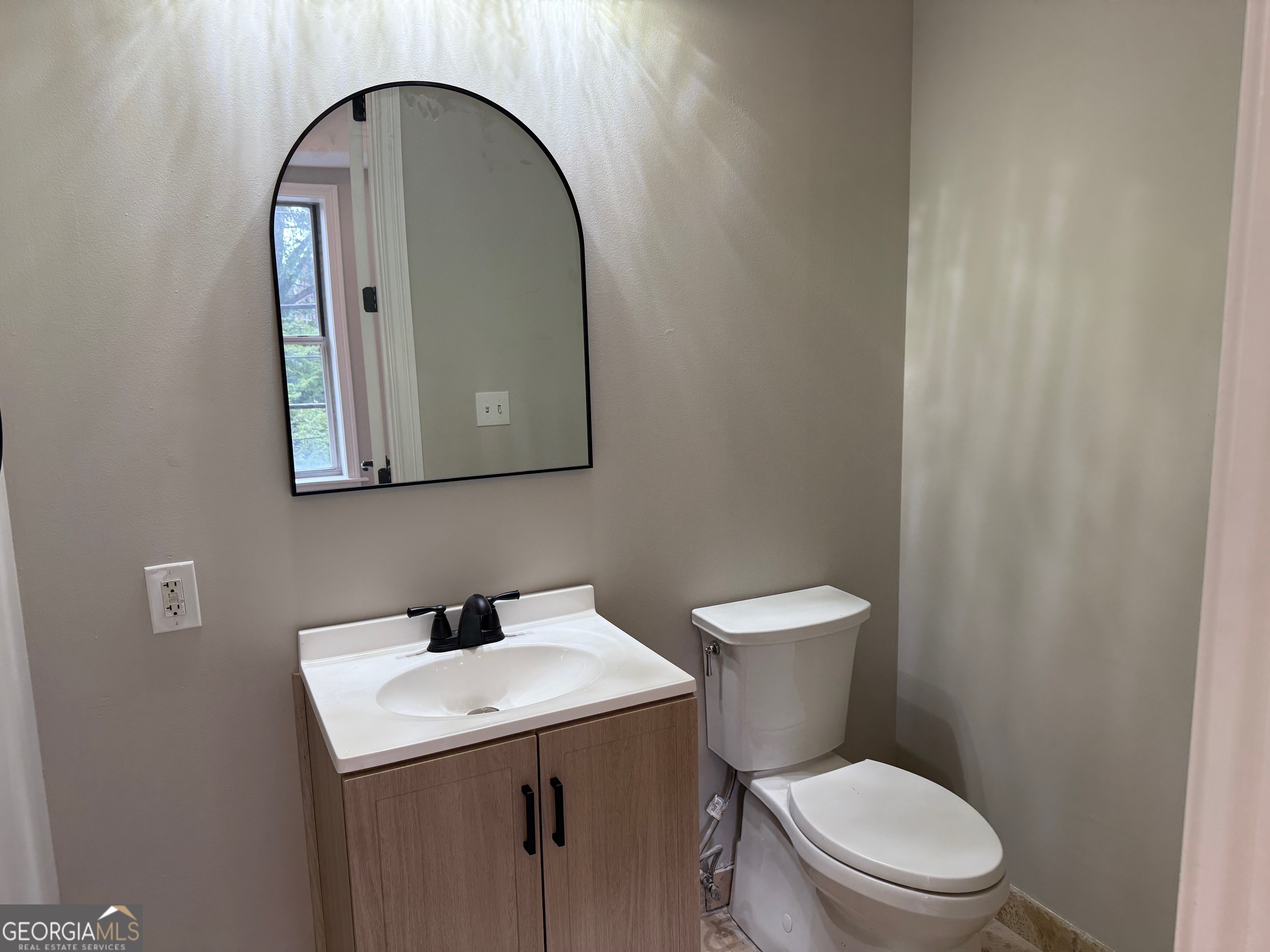 2255 Peachtree Road Northeast, Unit 322 Atlanta, GA 30305 - Photo 19 of 31 a bathroom with a toilet sink and mirror