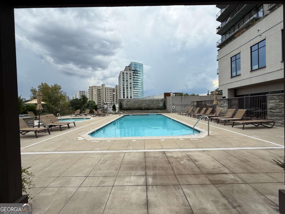 2255 Peachtree Road Northeast, Unit 322 Atlanta, GA 30305 - Photo 23 of 31 a view of a tennis ground with large trees
