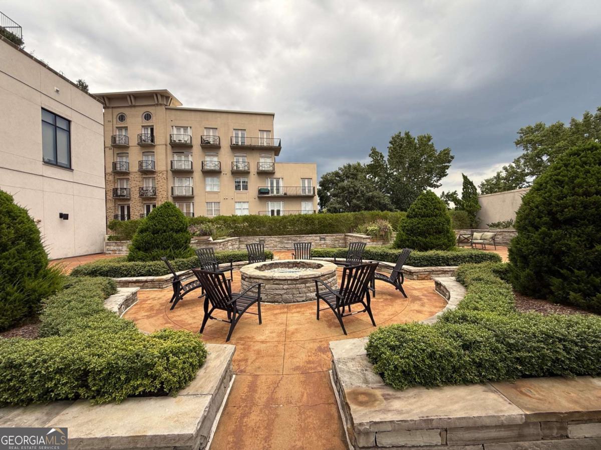 2255 Peachtree Road Northeast, Unit 322 Atlanta, GA 30305 - Photo 27 of 31 a view of a swimming pool with outdoor seating and plants