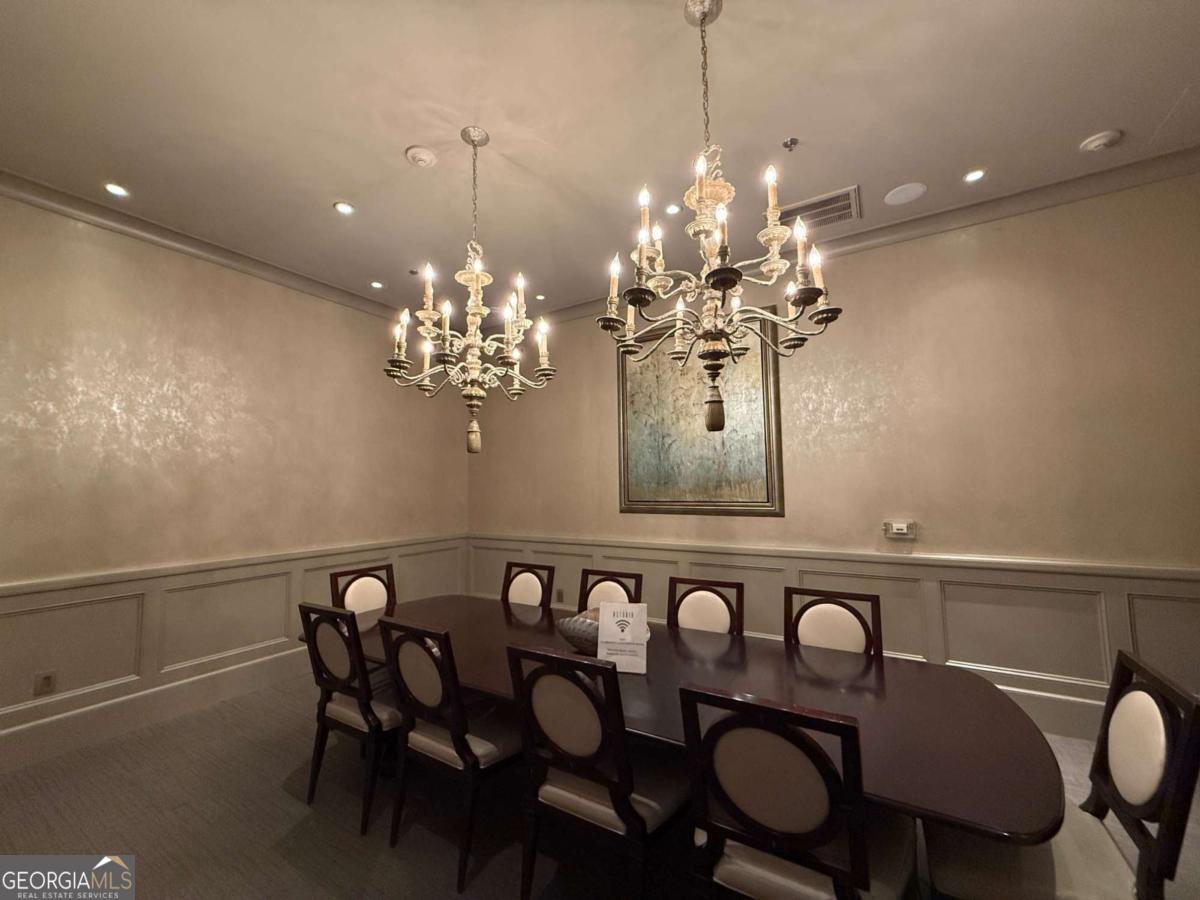 2255 Peachtree Road Northeast, Unit 322 Atlanta, GA 30305 - Photo 31 of 31 a view of a dining room with furniture and chandelier