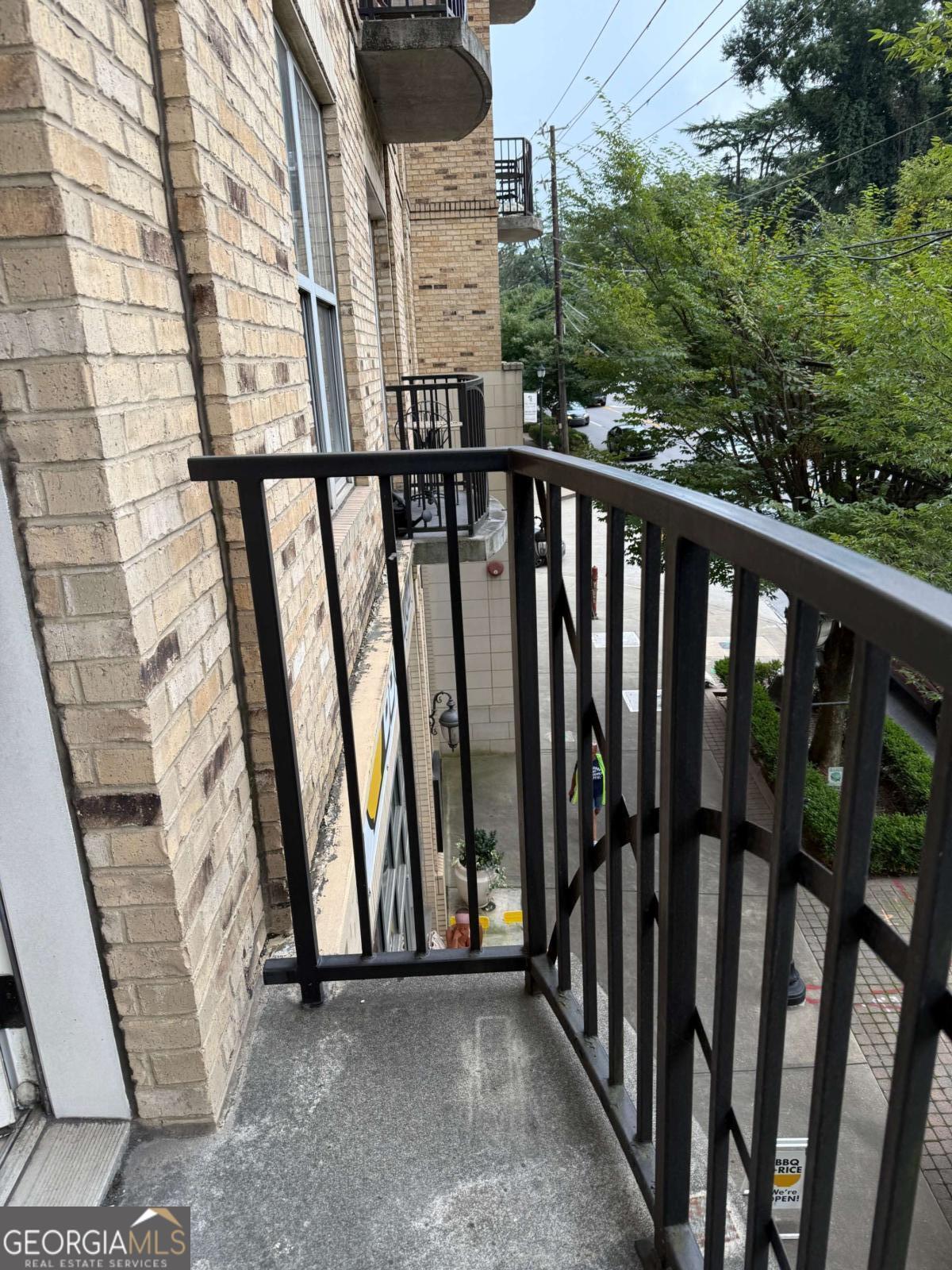 2255 Peachtree Road Northeast, Unit 322 Atlanta, GA 30305 - Photo 6 of 31 a view of a balcony with wooden fence