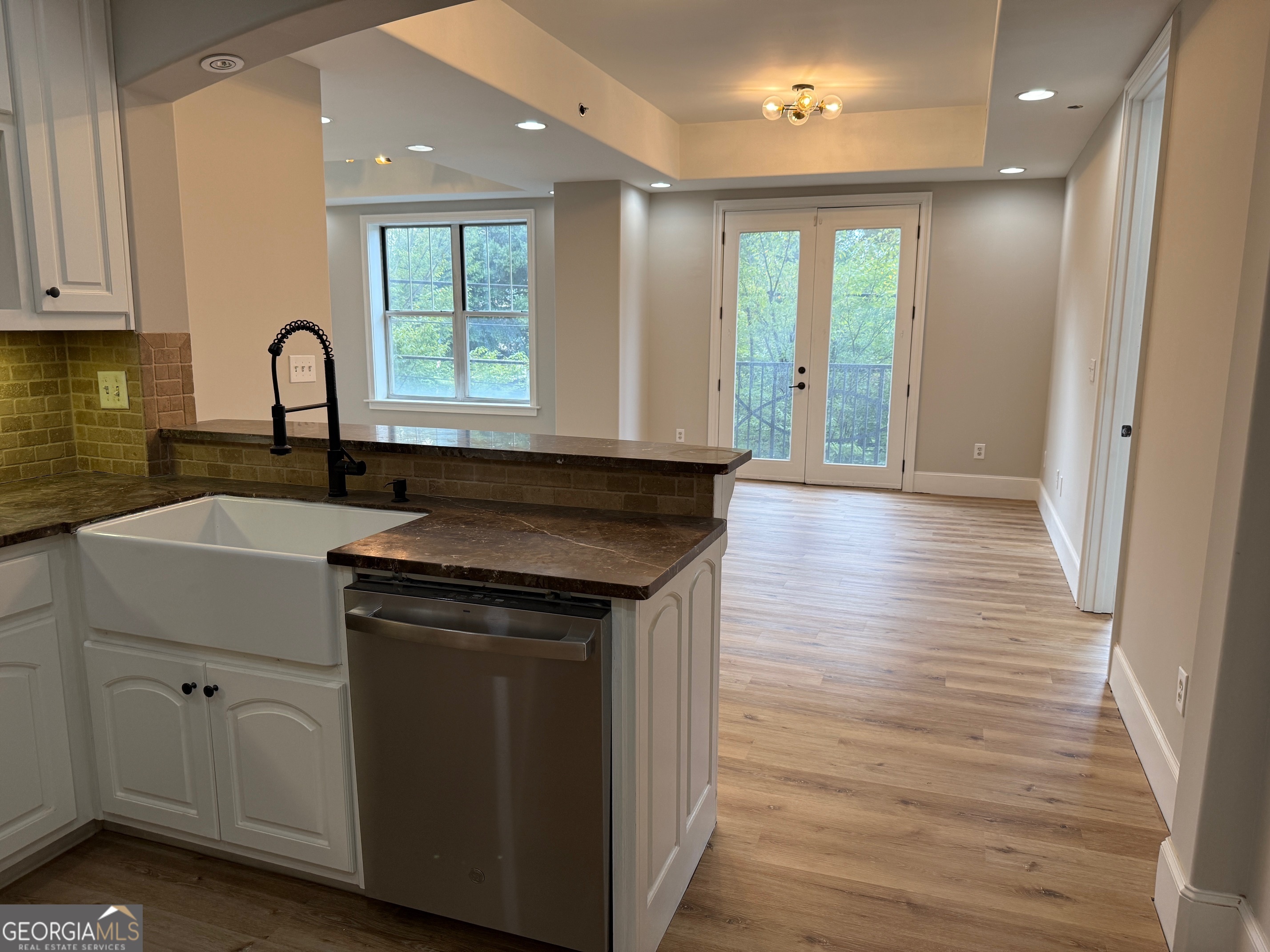 2255 Peachtree Road Northeast, Unit 322 Atlanta, GA 30305 - Photo 10 of 31 a view of a kitchen sink with wooden floor