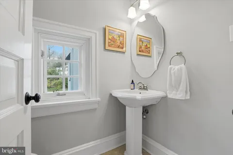 a bathroom with a sink a mirror and window