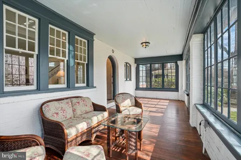 a living room with furniture and large windows