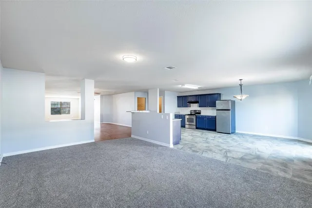 a view of a kitchen with a sink and cabinets