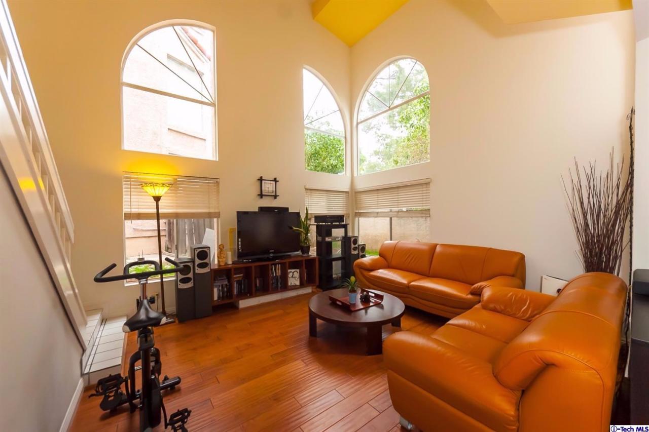 6255 Honolulu Avenue, Unit 5 Tujunga, CA 91042 - Photo 2 of 10 a living room with furniture a window and a flat screen tv