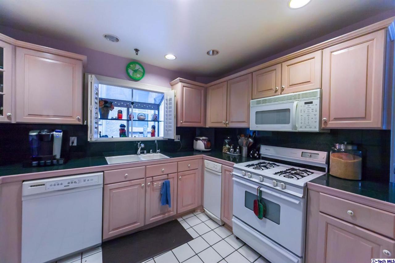 6255 Honolulu Avenue, Unit 5 Tujunga, CA 91042 - Photo 4 of 10 a kitchen with stainless steel appliances granite countertop a stove a sink and a microwave