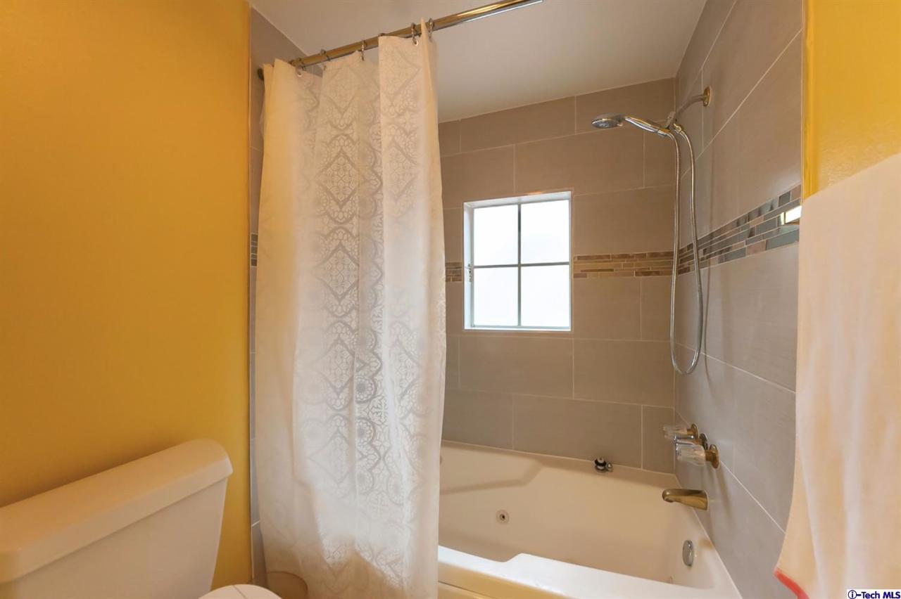 6255 Honolulu Avenue, Unit 5 Tujunga, CA 91042 - Photo 7 of 10 a bathroom with a bathtub and shower