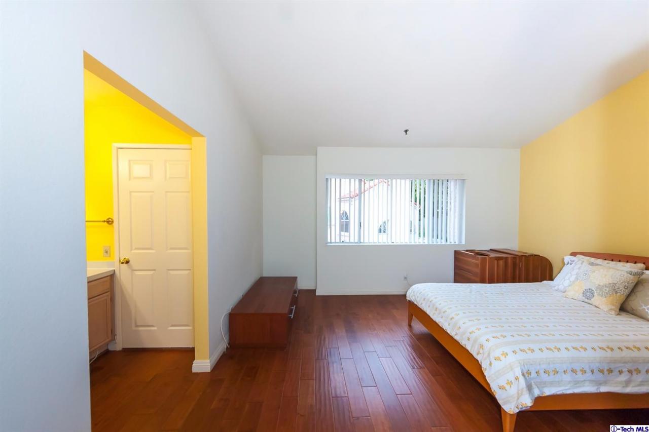 6255 Honolulu Avenue, Unit 5 Tujunga, CA 91042 - Photo 8 of 10 a bedroom with a bed and wooden floor