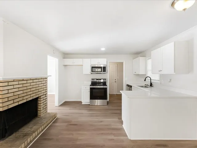 a kitchen with stainless steel appliances a stove sink and cabinets