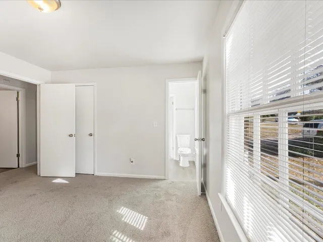a view of a livingroom with wooden floor and windows