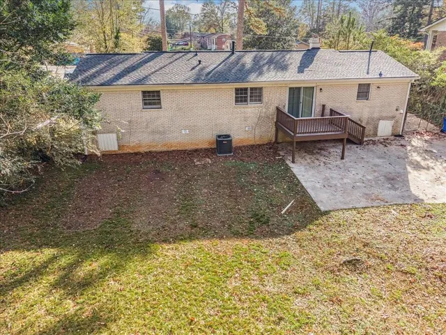 a view of a white house with a yard and sitting area