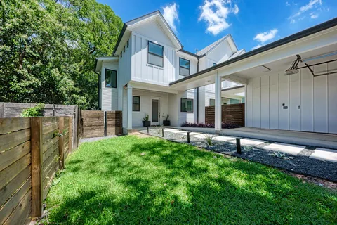a view of a house with a backyard