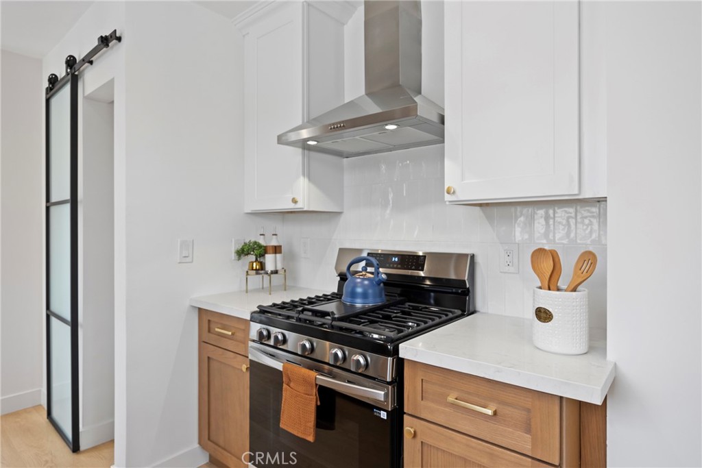 4254 West 58th Place Los Angeles, CA 90043 - Photo 13 of 53 a kitchen with a stove and a refrigerator
