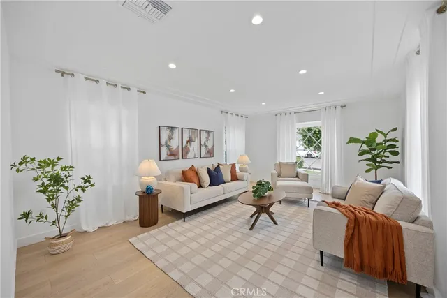 a living room with furniture and a potted plant