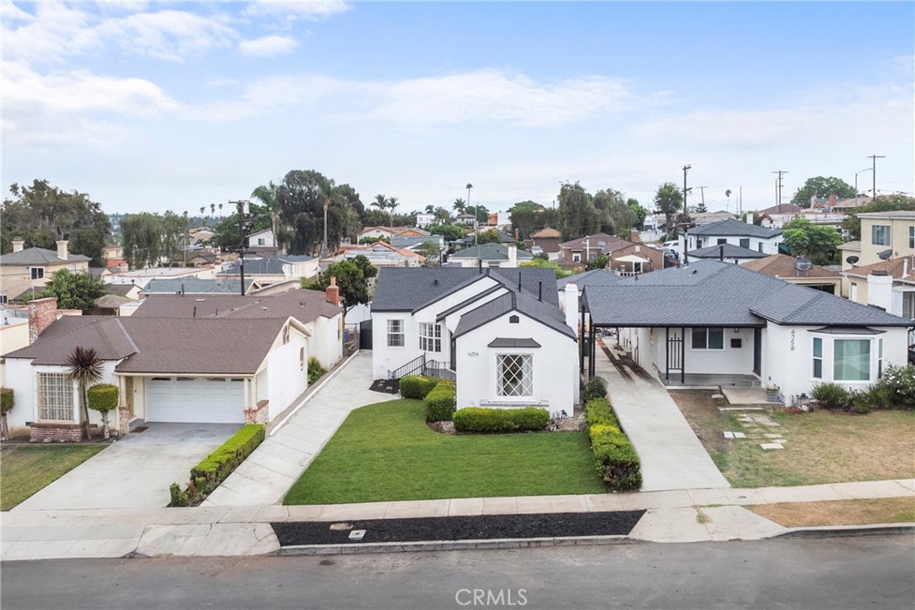 4254 West 58th Place Los Angeles, CA 90043 - Photo 2 of 53 a front view of a house with a garden and plants
