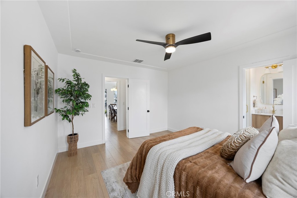 4254 West 58th Place Los Angeles, CA 90043 - Photo 22 of 53 a bedroom with a bed and a potted plant