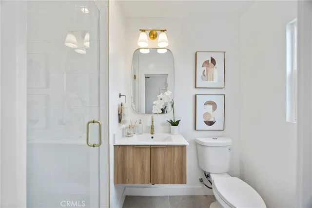 a bathroom with a double vanity sink mirror and shower