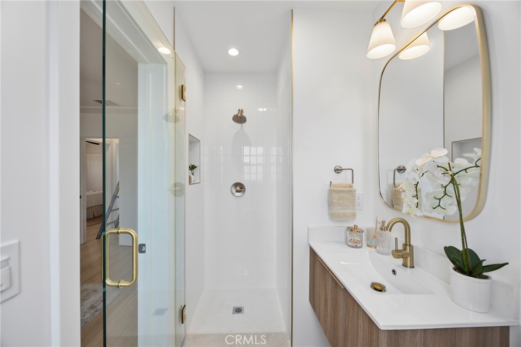 4254 West 58th Place Los Angeles, CA 90043 - Photo 25 of 53 a bathroom with a double vanity sink mirror and shower