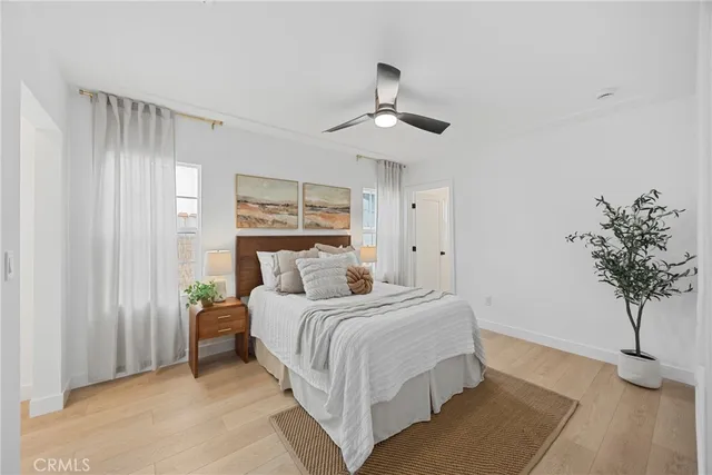 a bedroom with a bed and a potted plant