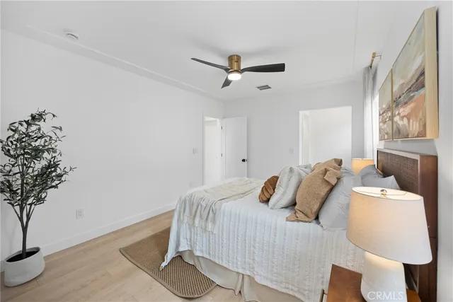 a bathroom with a bathtub shower sink vanity mirror and toilet
