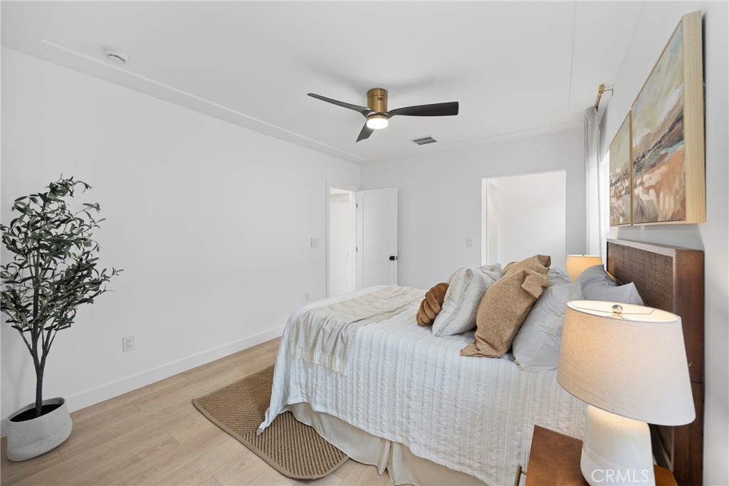 4254 West 58th Place Los Angeles, CA 90043 - Photo 27 of 53 a bedroom with a bed and a potted plant