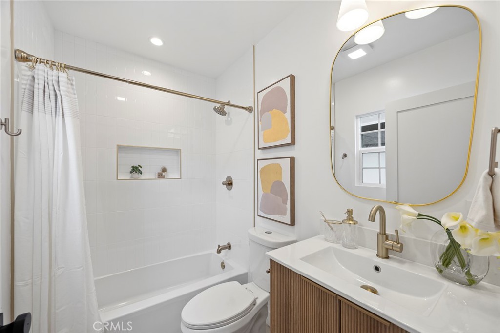 4254 West 58th Place Los Angeles, CA 90043 - Photo 28 of 53 a bathroom with a bathtub shower sink vanity mirror and toilet