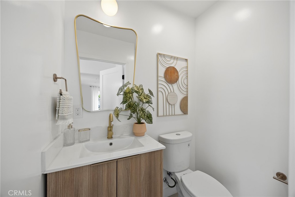 4254 West 58th Place Los Angeles, CA 90043 - Photo 32 of 53 a bathroom with a toilet sink and mirror