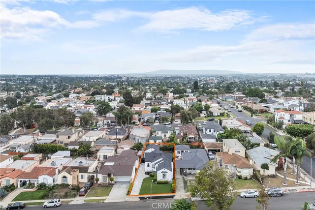an aerial view of residential building with green space