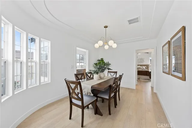 a view of a dining room with furniture and chandelier