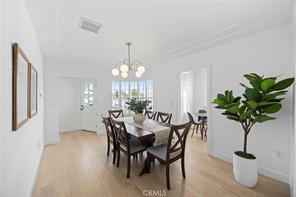 4254 West 58th Place Los Angeles, CA 90043 - Photo 7 of 53 a view of a dining room with furniture a chandelier and wooden floor