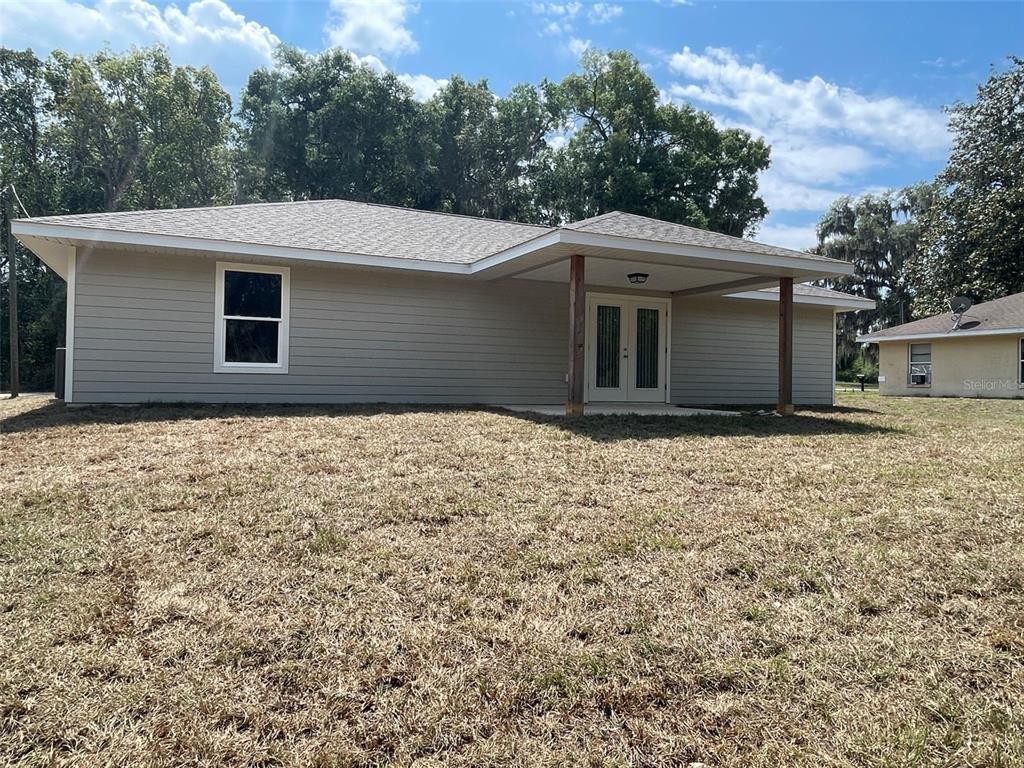8829 East Marvin Street Floral City, FL 34436 - Photo 12 of 12 a front view of house with yard and trees