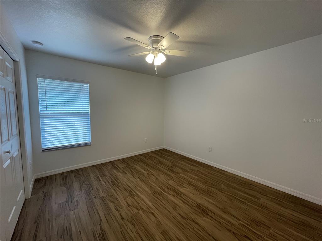 8829 East Marvin Street Floral City, FL 34436 - Photo 7 of 12 wooden floor in an empty room with a window